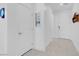 Bright hallway with white walls, tile floors, white doors, and modern decor at 9608 Bloodstone Ln, Las Vegas, NV 89143