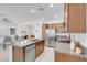 Open-concept kitchen with granite counters, stainless appliances, and seamless flow to the dining and office areas at 9608 Bloodstone Ln, Las Vegas, NV 89143