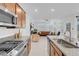 Modern kitchen with granite countertops, stainless steel appliances, and a view of the living area at 9608 Bloodstone Ln, Las Vegas, NV 89143