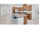 Stylish kitchen with granite countertops, a stainless steel refrigerator, and a functional island with barstool seating at 9608 Bloodstone Ln, Las Vegas, NV 89143