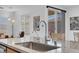 Close up of kitchen sink with granite counters, stainless steel faucet and view of the backyard at 9608 Bloodstone Ln, Las Vegas, NV 89143