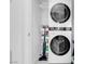 Convenient laundry room with stacked washer and dryer and storage at 9608 Bloodstone Ln, Las Vegas, NV 89143