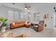Cozy living room featuring a sectional sofa, accent chair, neutral walls and ample natural light at 9608 Bloodstone Ln, Las Vegas, NV 89143