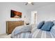 Comfortable main bedroom with plush bedding, wooden dresser, and a mounted television at 9608 Bloodstone Ln, Las Vegas, NV 89143