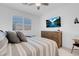 Well-lit main bedroom featuring a comfortable bed, wooden dresser, and plantation shutters at 9608 Bloodstone Ln, Las Vegas, NV 89143