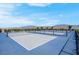 View of outdoor pickleball court with blue surface and black netting, set against a backdrop of mountains and blue sky at 9608 Bloodstone Ln, Las Vegas, NV 89143