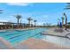 A luxurious swimming pool featuring lane markers, lounge chairs, and mature palm trees at 9608 Bloodstone Ln, Las Vegas, NV 89143