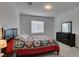 Bright bedroom featuring a soft carpet, window, and dresser with decor at 965 Nevada State Dr # 24201, Henderson, NV 89002