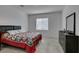Bright bedroom featuring a soft carpet, window, and dresser with decor at 965 Nevada State Dr # 24201, Henderson, NV 89002