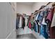 Walk-in closet with ample hanging space and clothing neatly arranged at 965 Nevada State Dr # 24201, Henderson, NV 89002