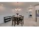Open-concept dining area with modern lighting adjacent to the kitchen and hallway at 965 Nevada State Dr # 24201, Henderson, NV 89002