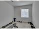 Bright exercise room featuring window, weight bench, and dumbbells on carpeted floor at 965 Nevada State Dr # 24201, Henderson, NV 89002