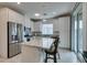 Modern kitchen featuring stainless steel appliances, a granite island, and ample cabinet space at 965 Nevada State Dr # 24201, Henderson, NV 89002