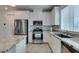 Bright kitchen with white cabinets, stainless steel appliances, and granite countertops at 965 Nevada State Dr # 24201, Henderson, NV 89002