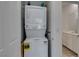 Convenient laundry area with stacked washer and dryer, adjacent to a well-lit bathroom at 965 Nevada State Dr # 24201, Henderson, NV 89002