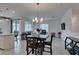 Bright, open-concept living area with dining table and modern furnishings for comfortable living at 965 Nevada State Dr # 24201, Henderson, NV 89002