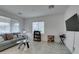 Bright living room with large windows, a comfortable sofa, and a sleek glass coffee table at 965 Nevada State Dr # 24201, Henderson, NV 89002