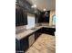 Modern kitchen features granite countertops, stainless steel appliances, and dark wood cabinetry at 9758 Panther Hollow St, Las Vegas, NV 89141