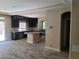 Spacious kitchen with granite countertops, stainless steel appliances, and dark cabinets at 9758 Panther Hollow St, Las Vegas, NV 89141