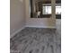 Neutral interior with a large opening to an adjacent fireplace and gray plank flooring at 9758 Panther Hollow St, Las Vegas, NV 89141