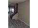 Open concept living room features wood-look floors and staircase to upper level at 9758 Panther Hollow St, Las Vegas, NV 89141