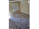 Neutral interior with a large window and gray plank flooring at 9758 Panther Hollow St, Las Vegas, NV 89141