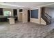 Open-concept living area with kitchen, dining, and staircase, perfect for entertaining at 9758 Panther Hollow St, Las Vegas, NV 89141