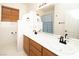Bathroom featuring double sinks and a large mirror, enhanced by wood accents and hardware at 1017 Fairbury St, Henderson, NV 89052