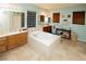 Bright bathroom features a soaking tub, double vanities, tile floors, and natural light from a window at 1017 Fairbury St, Henderson, NV 89052