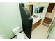 Bathroom featuring a commode and dual sinks with dark accents at 1017 Fairbury St, Henderson, NV 89052
