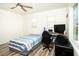 Bright bedroom with wood-look floors, a ceiling fan, and a computer desk near the window at 1017 Fairbury St, Henderson, NV 89052