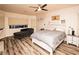 Inviting bedroom features hardwood floors, a ceiling fan, natural light, and a comfortable chaise lounge at 1017 Fairbury St, Henderson, NV 89052