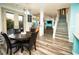 Bright dining room with table, a view to the backyard and stairs at 1017 Fairbury St, Henderson, NV 89052