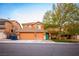 Two-story home featuring a three car garage and a well manicured front lawn with mature landscaping at 1017 Fairbury St, Henderson, NV 89052
