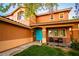 Inviting home entrance with desert landscaping, a vibrant blue door, and covered porch at 1017 Fairbury St, Henderson, NV 89052