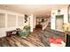 Spacious game room with wood laminate floors, a cozy sitting area, and stairs leading to the upper level at 1017 Fairbury St, Henderson, NV 89052