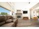 Bright living room features wood floors, a stone fireplace, and large windows for plenty of natural light at 1017 Fairbury St, Henderson, NV 89052