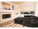 Cozy living room showcases a corner fireplace with mantle and an oversized sofa at 1017 Fairbury St, Henderson, NV 89052