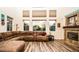Bright living room showcasing the fireplace, sectional couch, and many windows at 1017 Fairbury St, Henderson, NV 89052
