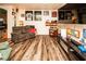 Cozy living room with wood laminate floors, a comfortable grey couch, and an entertainment center at 1017 Fairbury St, Henderson, NV 89052