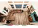 Bright living room with a fireplace, sectional sofa, hardwood floors, and natural light from tall windows at 1017 Fairbury St, Henderson, NV 89052