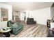 Bright living room with neutral tones featuring wood floors and comfortable seating arrangements at 1017 Fairbury St, Henderson, NV 89052