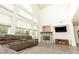 Open-concept living room with a soaring ceiling, modern fireplace, and ample natural light at 1017 Fairbury St, Henderson, NV 89052