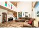 Spacious living room with a piano, sectional couch, and staircase at 1017 Fairbury St, Henderson, NV 89052