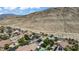 A neighborhood nestles against majestic mountains, blending nature and modern living at 10385 Grassyrock Ct, Las Vegas, NV 89129