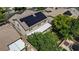 Aerial of a two-story home with solar panels, covered patio, and green lawn at 10385 Grassyrock Ct, Las Vegas, NV 89129