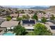 Pictureque view of a home with solar panels, pool, and mountain backdrop at 10385 Grassyrock Ct, Las Vegas, NV 89129