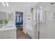 Bright bathroom featuring double vanity, glass shower, and soaking tub with wood-look floors at 10385 Grassyrock Ct, Las Vegas, NV 89129