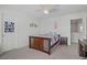 Cozy bedroom with a wooden bed frame and a ceiling fan at 10385 Grassyrock Ct, Las Vegas, NV 89129