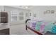 Bright bedroom with large windows, neutral carpet and ceiling fan at 10385 Grassyrock Ct, Las Vegas, NV 89129